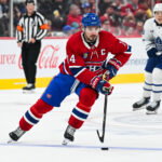 Sep 19, 2026; Montreal, Quebec, CAN; Montreal Canadiens center Nick Suzuki (14) plays the puck against the Toronto Maple Leafs during the second period at Bell Centre. Mandatory Credit: David Kirouac-Imagn Images