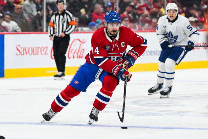 Sep 19, 2026; Montreal, Quebec, CAN; Montreal Canadiens center Nick Suzuki (14) plays the puck against the Toronto Maple Leafs during the second period at Bell Centre. Mandatory Credit: David Kirouac-Imagn Images