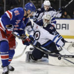 Nov 12, 2024; New York, New York, USA; Winnipeg Jets goaltender Connor Hellebuyck (37) defends against a shot on goal attempt by New York Rangers right wing Reilly Smith (91) in the second period at Madison Square Garden. Mandatory Credit: Wendell Cruz-Imagn Images