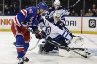 Nov 12, 2024; New York, New York, USA; Winnipeg Jets goaltender Connor Hellebuyck (37) defends against a shot on goal attempt by New York Rangers right wing Reilly Smith (91) in the second period at Madison Square Garden. Mandatory Credit: Wendell Cruz-Imagn Images