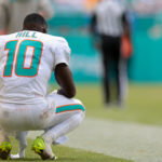 Sep 14, 2025; Miami Gardens, Florida, USA; Miami Dolphins wide receiver Tyreek Hill (10) watches from the sideline against the New England Patriots during the fourth quarter at Hard Rock Stadium. Mandatory Credit: Sam Navarro-Imagn Images