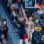 Mar 27, 2026; San Francisco, California, USA; Washington Wizards center Alex Sarr (20) shoots over Golden State Warriors center Kristaps Porzingis (7) during the third quarter at Chase Center. Mandatory Credit: Neville E. Guard-Imagn Images