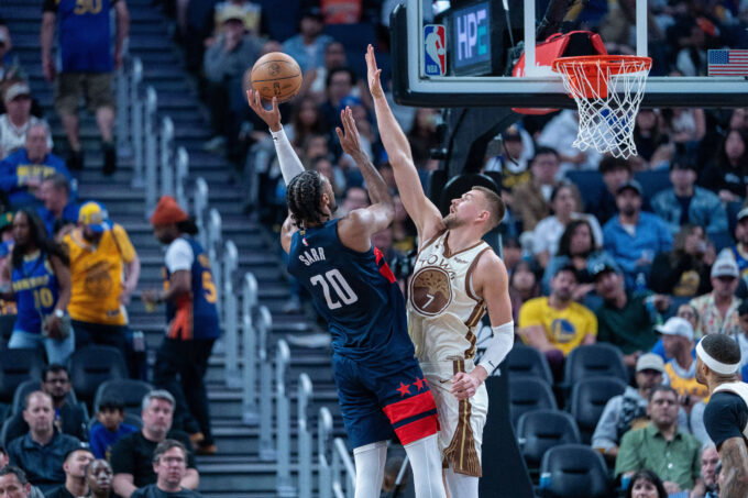 Mar 27, 2026; San Francisco, California, USA; Washington Wizards center Alex Sarr (20) shoots over Golden State Warriors center Kristaps Porzingis (7) during the third quarter at Chase Center. Mandatory Credit: Neville E. Guard-Imagn Images