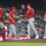Aug 19, 2026; Houston, Texas, USA; Los Angeles Angels manager Kurt Suzuki (8) takes the ball from pitcher Tayler Saucedo (55) during a pitching change in the eighth inning against the Houston Astros at Daikin Park. Mandatory Credit: Troy Taormina-Imagn Images