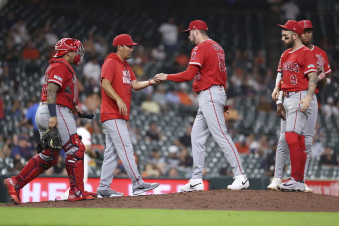 Aug 19, 2026; Houston, Texas, USA; Los Angeles Angels manager Kurt Suzuki (8) takes the ball from pitcher Tayler Saucedo (55) during a pitching change in the eighth inning against the Houston Astros at Daikin Park. Mandatory Credit: Troy Taormina-Imagn Images