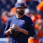 Sep 20, 2026; Denver, Colorado, USA; Denver Broncos offensive coordinator Davis Webb on the field prior to a game Jacksonville Jaguars at Empower Field at Mile High. Mandatory Credit: Ron Chenoy-Imagn Images