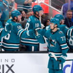 Sep 22, 2026; San Jose, California, USA; San Jose Sharks center Michael Misa (77) shakes hands with teammates on the bench aftre scoring a goal against Vegas Golden Knights goaltender Carter Hart (not pictured) during the third period at SAP Center at San Jose. Mandatory Credit: Robert Edwards-Imagn Images