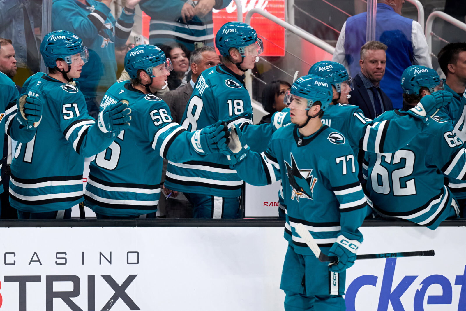 Sep 22, 2026; San Jose, California, USA; San Jose Sharks center Michael Misa (77) shakes hands with teammates on the bench aftre scoring a goal against Vegas Golden Knights goaltender Carter Hart (not pictured) during the third period at SAP Center at San Jose. Mandatory Credit: Robert Edwards-Imagn Images