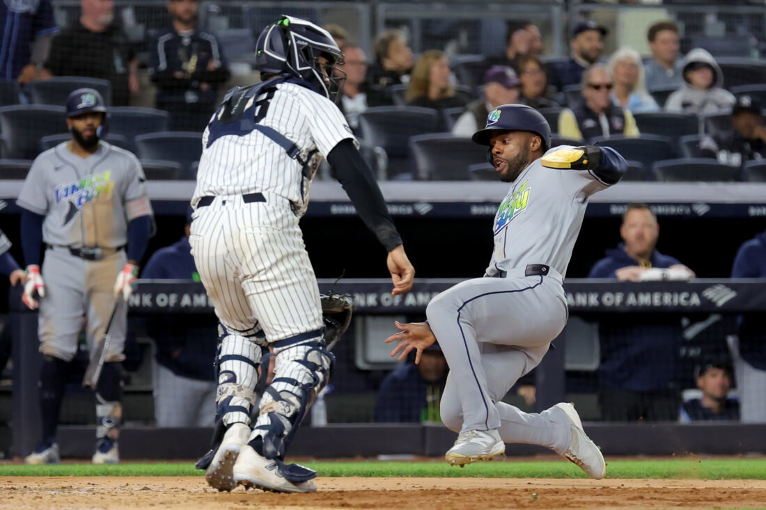 Sep 22, 2026; Bronx, New York, USA; Tampa Bay Rays center fielder Cedric Mullins (31) scores a run against New York Yankees catcher Austin Wells (28) on a two run single by designated hitter Yandy Diaz (not pictured) during the ninth inning at Yankee Stadium. Mandatory Credit: Brad Penner-Imagn Images