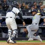 Sep 22, 2026; Bronx, New York, USA; Tampa Bay Rays center fielder Cedric Mullins (31) scores a run against New York Yankees catcher Austin Wells (28) on a two run single by designated hitter Yandy Diaz (not pictured) during the ninth inning at Yankee Stadium. Mandatory Credit: Brad Penner-Imagn Images