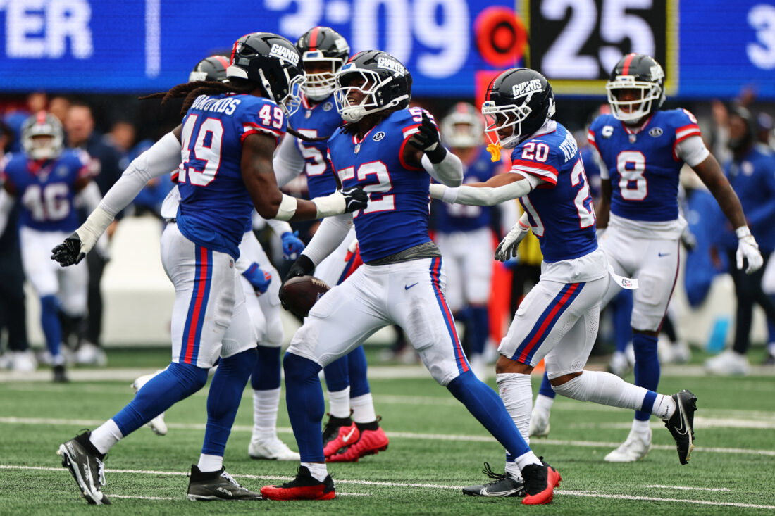 Oct 4, 2026; East Rutherford, New Jersey, USA; New York Giants linebacker Arvell Reese (52) and New York Giants linebacker Tremaine Edmunds (49) celebrate an interception during the second quarter at MetLife Stadium. Mandatory Credit: Vincent Carchietta-Imagn Images