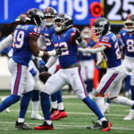 Oct 4, 2026; East Rutherford, New Jersey, USA; New York Giants linebacker Arvell Reese (52) and New York Giants linebacker Tremaine Edmunds (49) celebrate an interception during the second quarter at MetLife Stadium. Mandatory Credit: Vincent Carchietta-Imagn Images