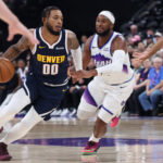 Oct 6, 2026; Salt Lake City, Utah, USA; Denver Nuggets forward Cam Whitmore (00) drives against Utah Jazz guard Josh Okogie (21) during the second half at Delta Center. Mandatory Credit: Rob Gray-Imagn Images