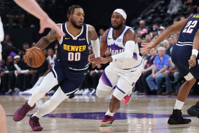 Oct 6, 2026; Salt Lake City, Utah, USA; Denver Nuggets forward Cam Whitmore (00) drives against Utah Jazz guard Josh Okogie (21) during the second half at Delta Center. Mandatory Credit: Rob Gray-Imagn Images