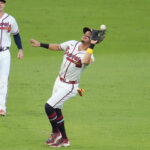 Oct 7, 2026; Cumberland, Georgia, USA; Atlanta Braves outfielder Mauricio Dubon (14) makes an error on a hit by Los Angeles Dodgers third baseman Max Muncy (not pictured) during the second inning in game four of the NLDS for the 2026 MLB Playoffs at Truist Park.