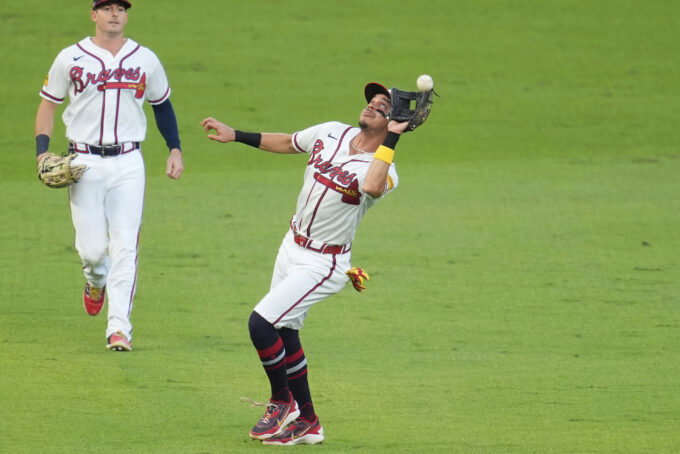 Oct 7, 2026; Cumberland, Georgia, USA; Atlanta Braves outfielder Mauricio Dubon (14) makes an error on a hit by Los Angeles Dodgers third baseman Max Muncy (not pictured) during the second inning in game four of the NLDS for the 2026 MLB Playoffs at Truist Park.