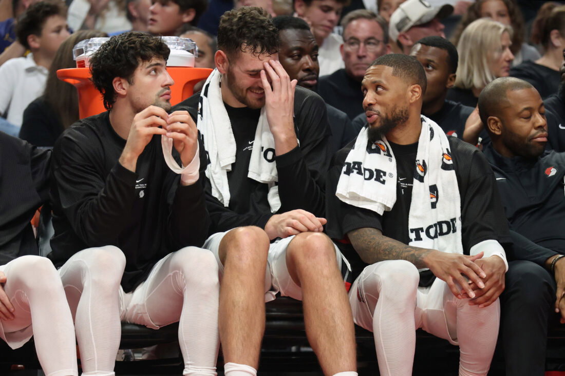 Oct 7, 2026; Portland, Oregon, USA; Portland Trail Blazers forward Deni Avdija (8), center Donovan Clingan (23) and guard Damian Lillard (0) sit ion the bench during the second half against the Golden State Warriors at Moda Center. Mandatory Credit: Jaime Valdez-Imagn Images