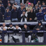 Oct 7, 2026; Bronx, New York, USA; New York Yankees third baseman Ryan McMahon (19) and first baseman Paul Goldschmidt (48) and catcher Austin Wells (28) and designated hitter Ben Rice (22) and starting pitcher Max Fried (54) and injured right fielder Aaron Judge (99) and center fielder Trent Grisham (12) watch from the dugout during the eighth inning of game three of the ALDS against the Tampa Bay Rays during the 2026 MLB Playoffs at Yankee Stadium.