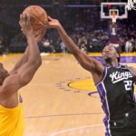Oct 8, 2026; Los Angeles, California, USA; Los Angeles Lakers forward Ak Okereke (31) and Sacramento Kings forward Jonathan Mogbo (22) reach for a rebound at Crypto.com Arena. Mandatory Credit: Jayne Kamin-Oncea-Imagn Images