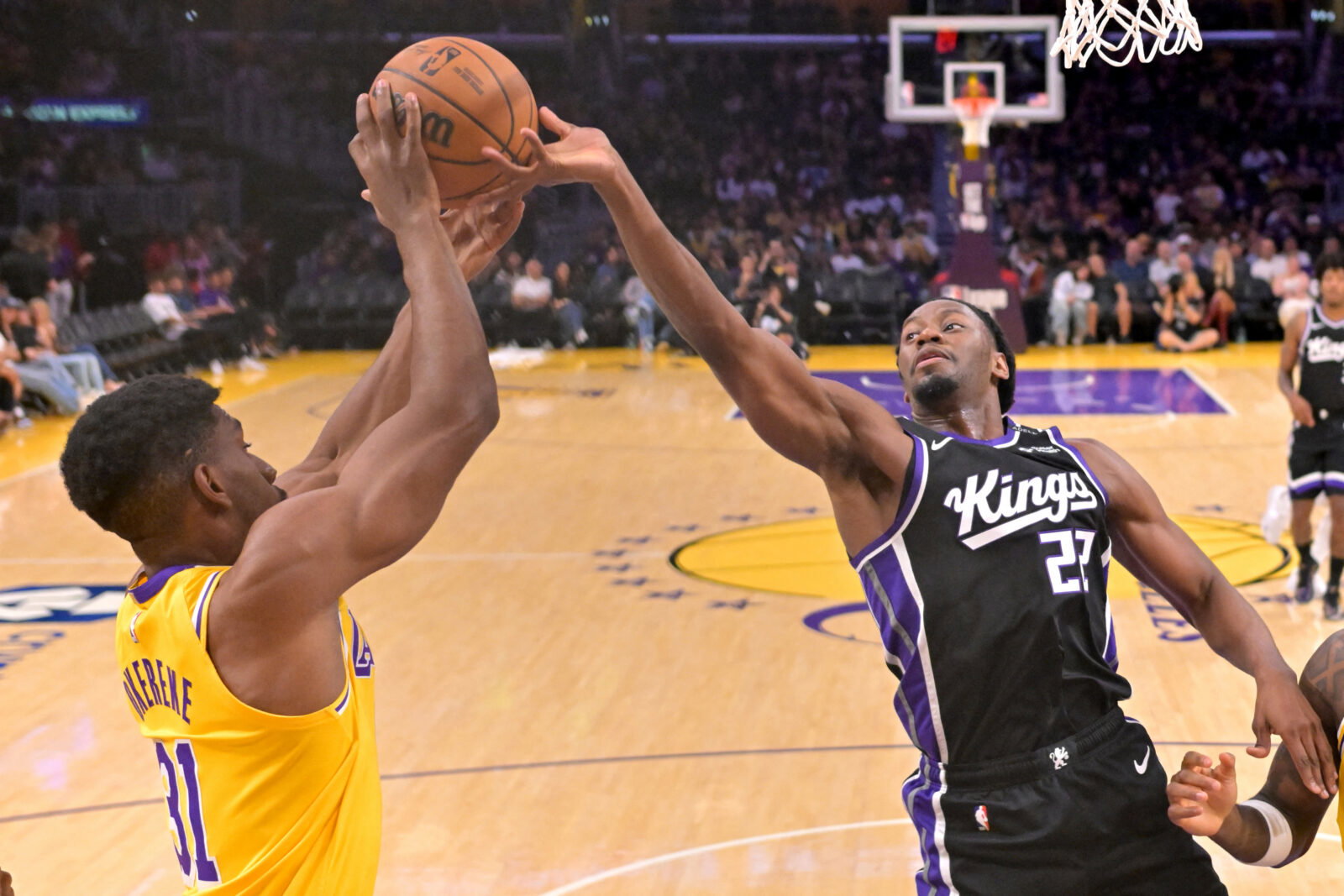Oct 8, 2026; Los Angeles, California, USA; Los Angeles Lakers forward Ak Okereke (31) and Sacramento Kings forward Jonathan Mogbo (22) reach for a rebound at Crypto.com Arena. Mandatory Credit: Jayne Kamin-Oncea-Imagn Images