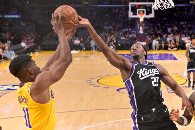 Oct 8, 2026; Los Angeles, California, USA; Los Angeles Lakers forward Ak Okereke (31) and Sacramento Kings forward Jonathan Mogbo (22) reach for a rebound at Crypto.com Arena. Mandatory Credit: Jayne Kamin-Oncea-Imagn Images