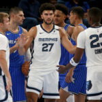 Oct 7, 2026; Memphis, Tennessee, USA; Memphis Grizzlies forward Cameron Boozer (27) reacts with guard Cam Spencer (24) and forward Cedric Coward (23) during the second quarter against the Orlando Magic at FedExForum.