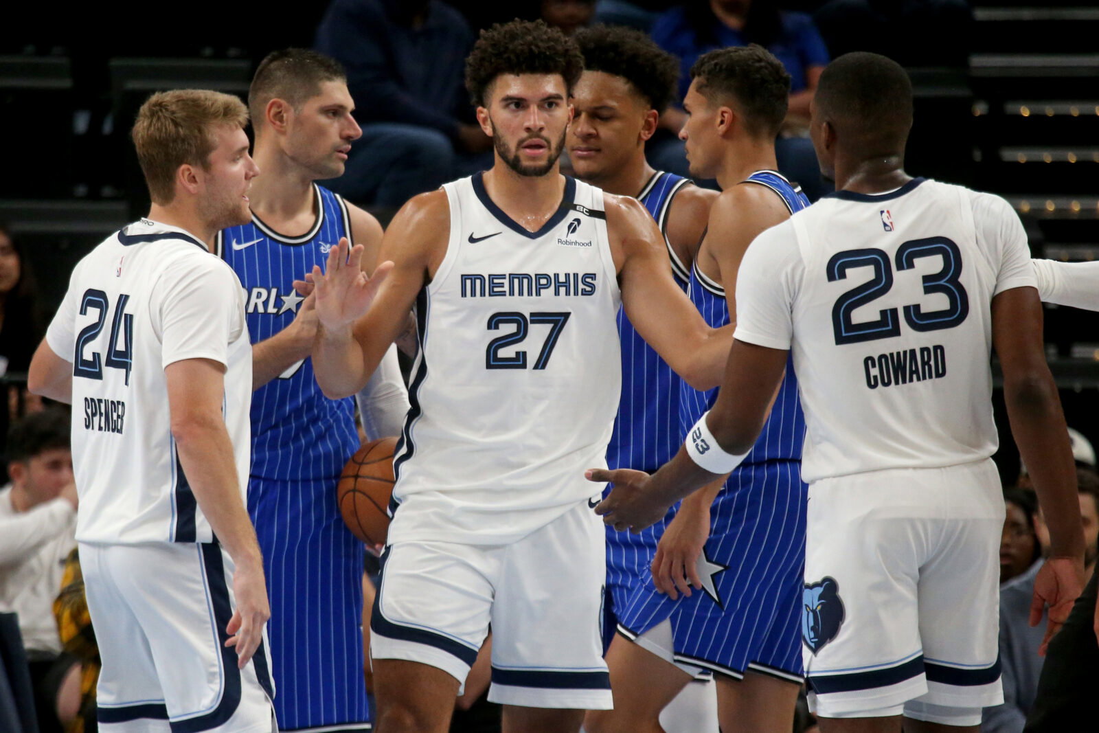 Oct 7, 2026; Memphis, Tennessee, USA; Memphis Grizzlies forward Cameron Boozer (27) reacts with guard Cam Spencer (24) and forward Cedric Coward (23) during the second quarter against the Orlando Magic at FedExForum.