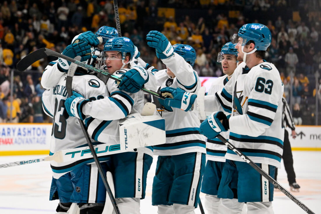 Oct 15, 2026; Nashville, Tennessee, USA; San Jose Sharks goaltender Alex Nedeljkovic (33) celebrates with his teammates after the shootout win Nashville Predators during the overtime period at Bridgestone Arena. Mandatory Credit: Steve Roberts-Imagn Images