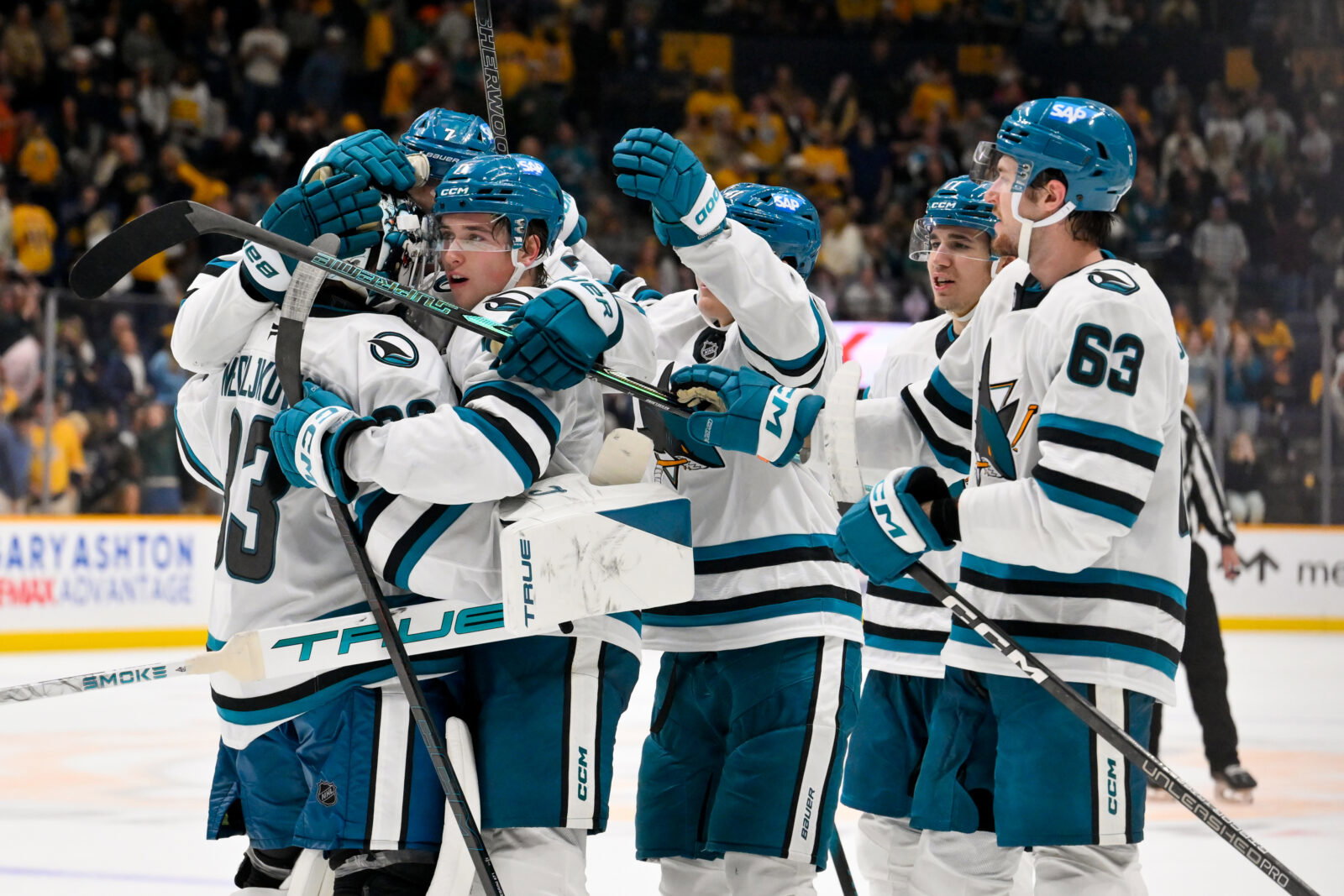 Oct 15, 2026; Nashville, Tennessee, USA; San Jose Sharks goaltender Alex Nedeljkovic (33) celebrates with his teammates after the shootout win Nashville Predators during the overtime period at Bridgestone Arena. Mandatory Credit: Steve Roberts-Imagn Images