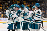 Oct 15, 2026; Nashville, Tennessee, USA; San Jose Sharks goaltender Alex Nedeljkovic (33) celebrates with his teammates after the shootout win Nashville Predators during the overtime period at Bridgestone Arena. Mandatory Credit: Steve Roberts-Imagn Images