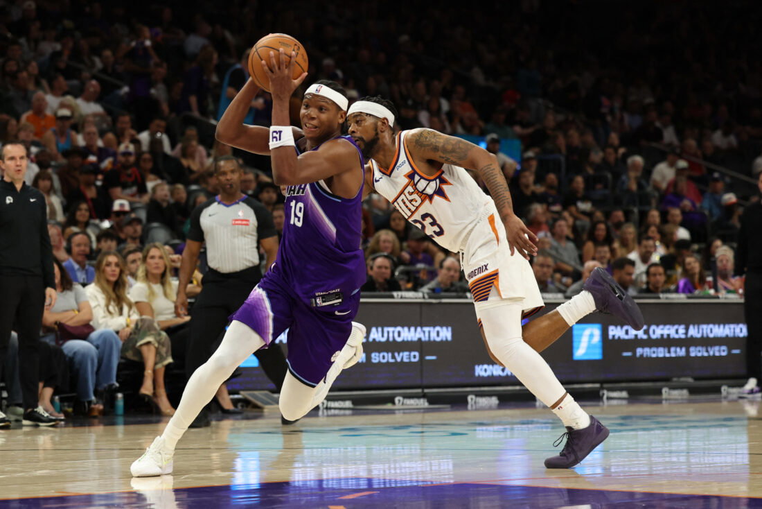 Oct 16, 2026; Phoenix, Arizona, USA; Utah Jazz forward Ace Bailey (19) dribbles against Phoenix Suns guard Jordan Goodwin (23) in the first half at Mortgage Matchup Center. Mandatory Credit: Anna Carrington-Imagn Images