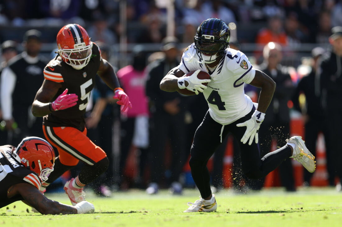 Oct 18, 2026; Cleveland, Ohio, USA; Baltimore Ravens wide receiver Zay Flowers (4) runs the ball ahead of Cleveland Browns linebacker Quincy Williams (5) in the first quarter at Huntington Bank Field. Mandatory Credit: Scott Galvin-Imagn Images