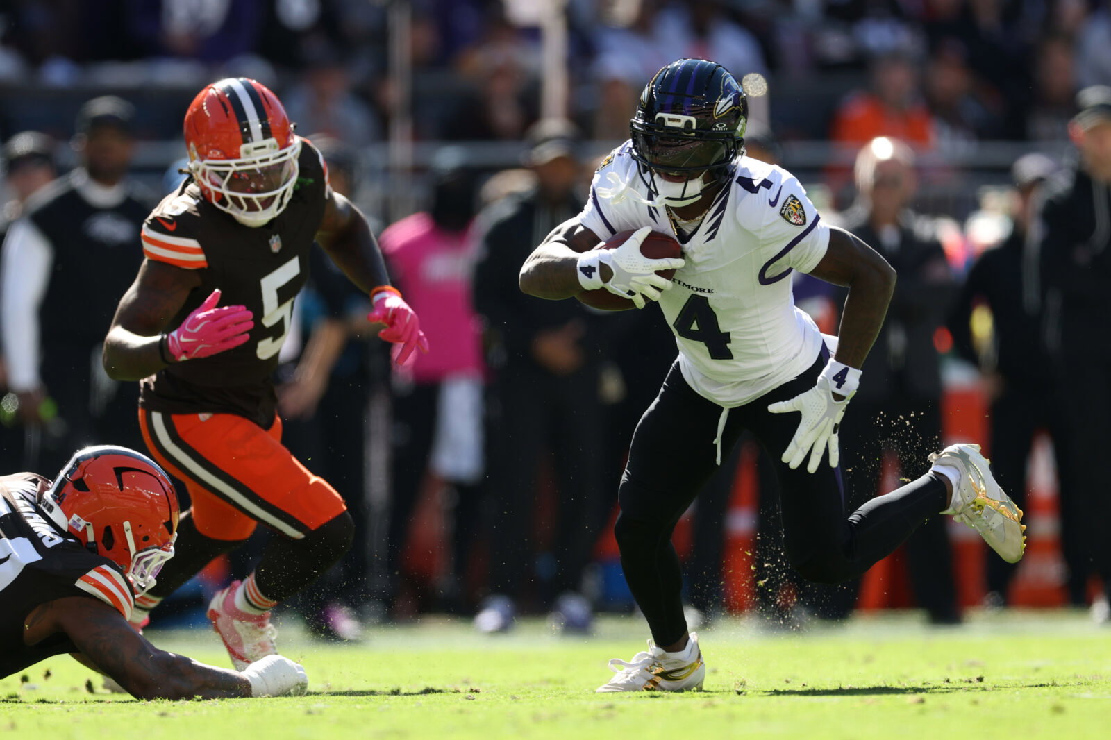 Oct 18, 2026; Cleveland, Ohio, USA; Baltimore Ravens wide receiver Zay Flowers (4) runs the ball ahead of Cleveland Browns linebacker Quincy Williams (5) in the first quarter at Huntington Bank Field. Mandatory Credit: Scott Galvin-Imagn Images