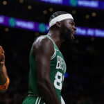 Oct 23, 2026; Boston, Massachusetts, USA; New York Knicks center Karl-Anthony Towns (32) holds the ball as Boston Celtics center Neemias Queta (88) celebrates a basket during the second half at TD Garden. Mandatory Credit: