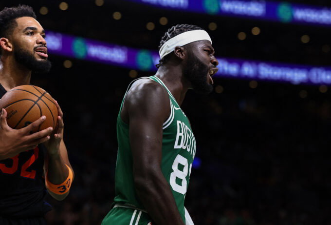 Oct 23, 2026; Boston, Massachusetts, USA; New York Knicks center Karl-Anthony Towns (32) holds the ball as Boston Celtics center Neemias Queta (88) celebrates a basket during the second half at TD Garden. Mandatory Credit: