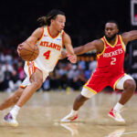 Oct 24, 2026; Atlanta, Georgia, USA; Atlanta Hawks guard Kingston Flemings (4) dribbles against Houston Rockets guard Bruce Thornton (2) in the second quarter at State Farm Arena. Mandatory Credit: Colin Hubbard-Imagn Images