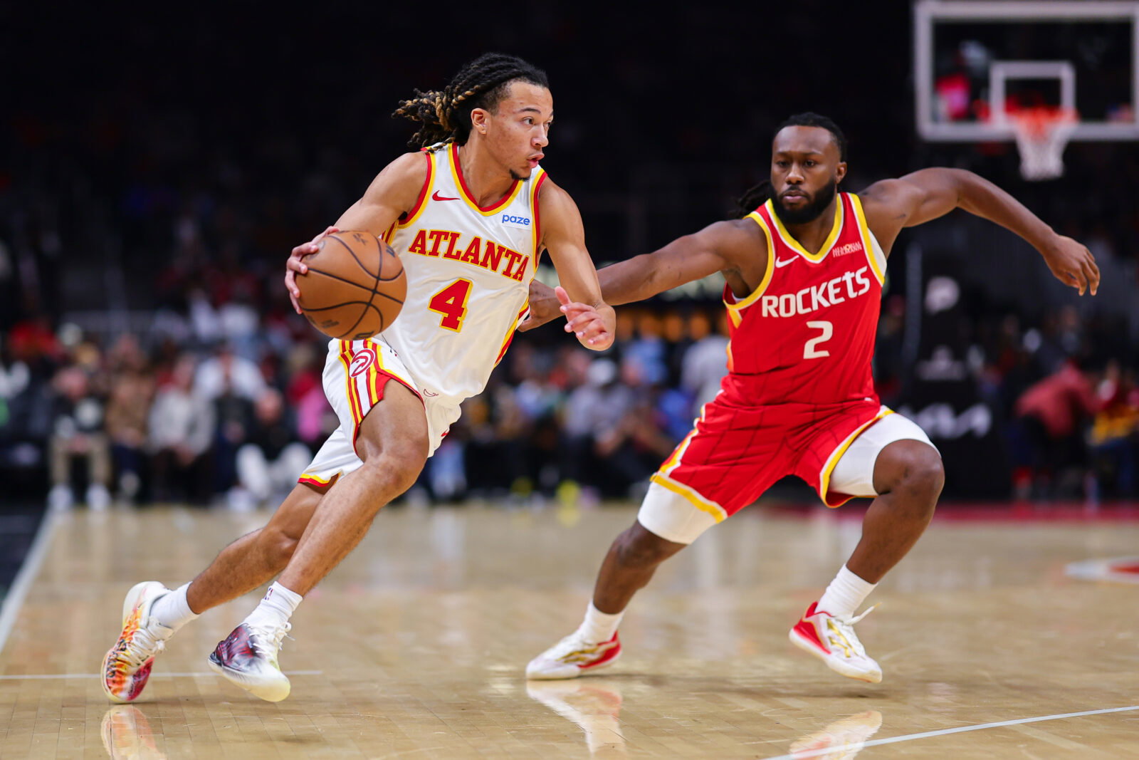 Oct 24, 2026; Atlanta, Georgia, USA; Atlanta Hawks guard Kingston Flemings (4) dribbles against Houston Rockets guard Bruce Thornton (2) in the second quarter at State Farm Arena. Mandatory Credit: Colin Hubbard-Imagn Images