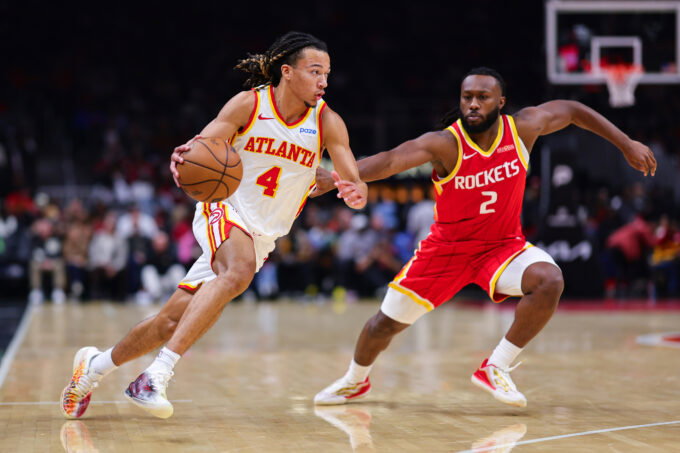 Oct 24, 2026; Atlanta, Georgia, USA; Atlanta Hawks guard Kingston Flemings (4) dribbles against Houston Rockets guard Bruce Thornton (2) in the second quarter at State Farm Arena. Mandatory Credit: Colin Hubbard-Imagn Images