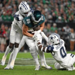 Oct 26, 2026; Philadelphia, Pennsylvania, USA; Philadelphia Eagles tight end Dallas Goedert (88) is tackled by Dallas Cowboys cornerback Joey Porter Jr. (25) and linebacker DeMarvion Overshown (0) during the first half at Lincoln Financial Field. Mandatory Credit: Eric Hartline-Imagn Images