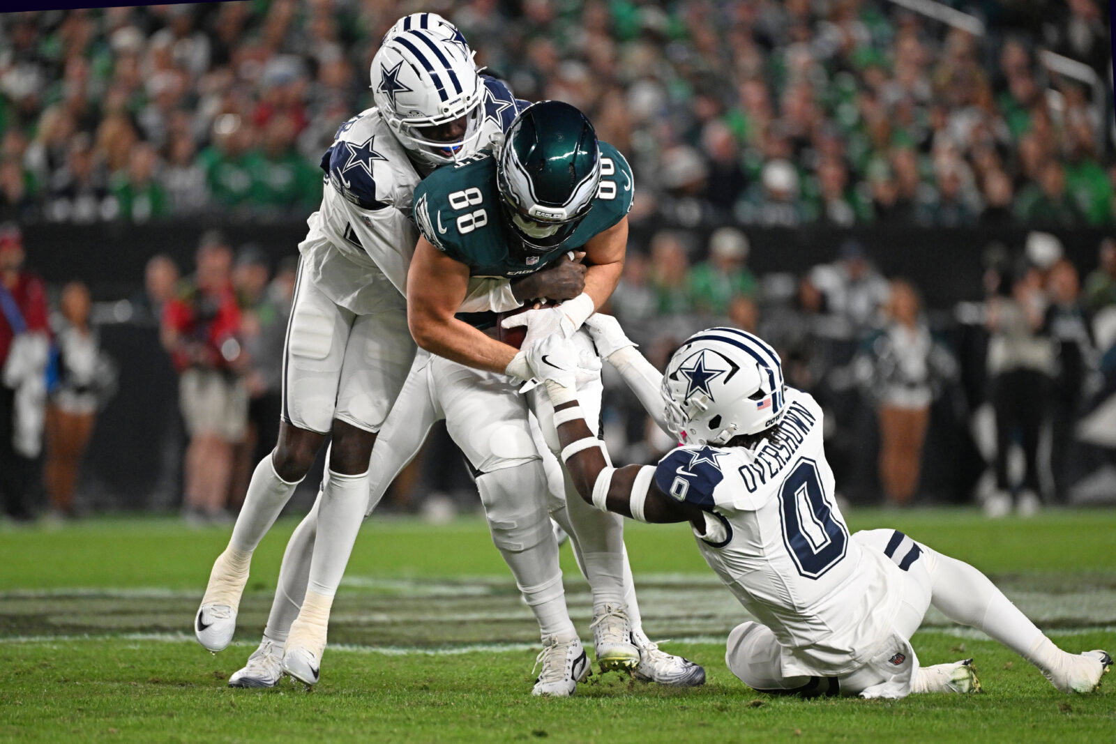 Oct 26, 2026; Philadelphia, Pennsylvania, USA; Philadelphia Eagles tight end Dallas Goedert (88) is tackled by Dallas Cowboys cornerback Joey Porter Jr. (25) and linebacker DeMarvion Overshown (0) during the first half at Lincoln Financial Field. Mandatory Credit: Eric Hartline-Imagn Images